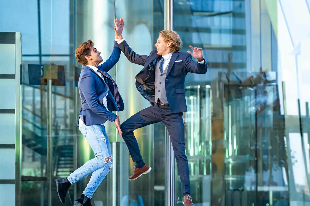 two successful men high fiving eachother with excitement